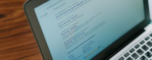 A close-up view of a laptop displaying a search engine page.